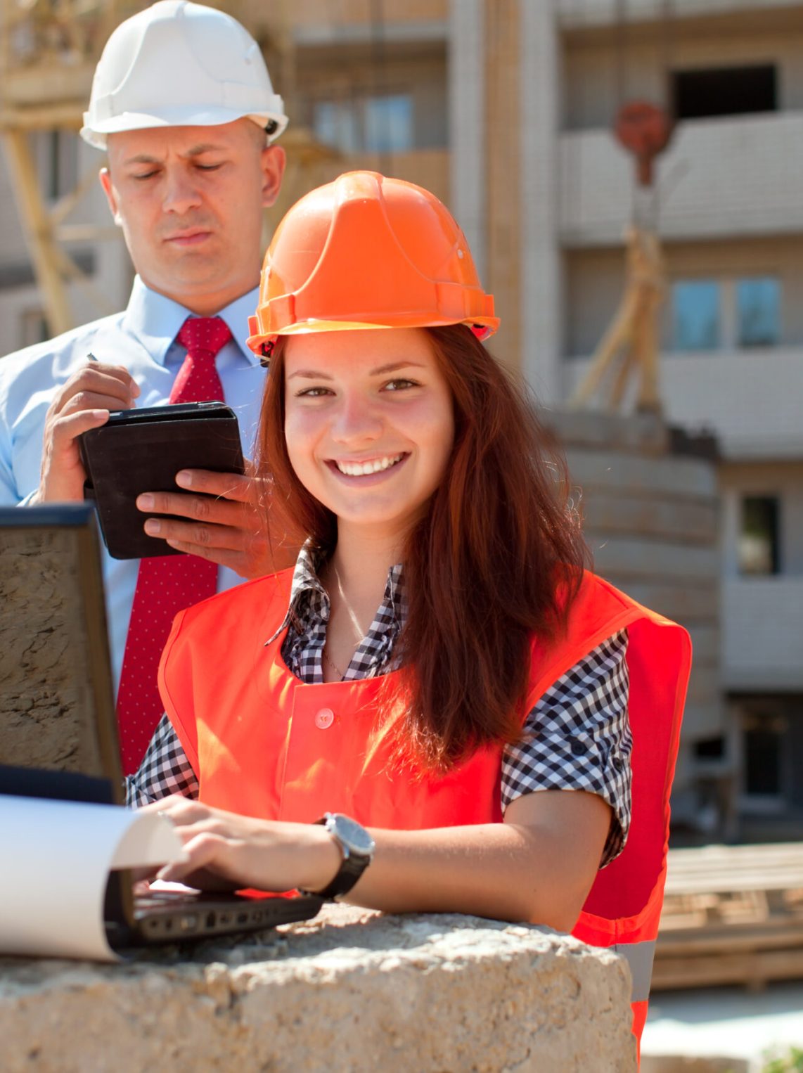 White-collar workers wearing protective helmet works on the building site